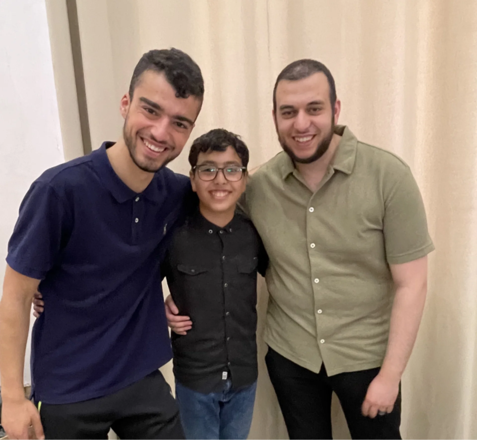 Three people posing together